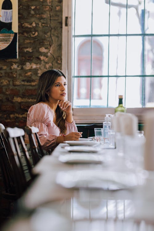 A woman sitting at a table in a restaurant