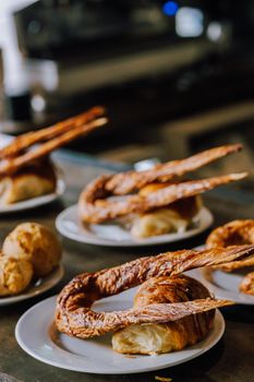 Delicious croissants and pastries served on plates, capturing a cozy cafe ambiance.