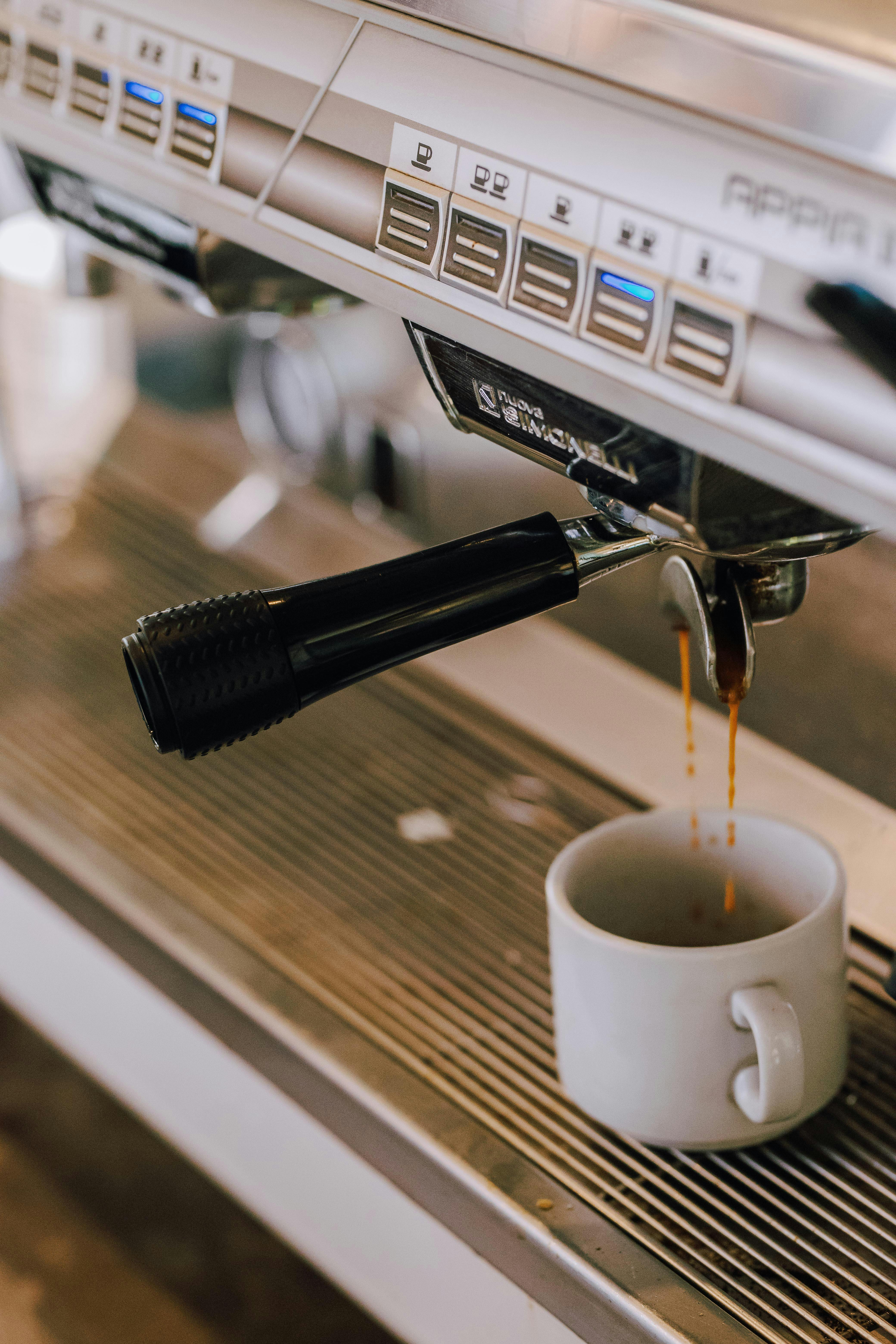 Close-up of espresso pouring from a coffee machine into a cup in a Buenos Aires cafe.