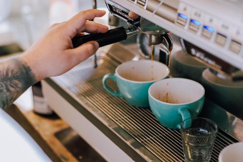 Free A barista prepares fresh espresso at a café in Buenos Aires, Argentina. Stock Photo