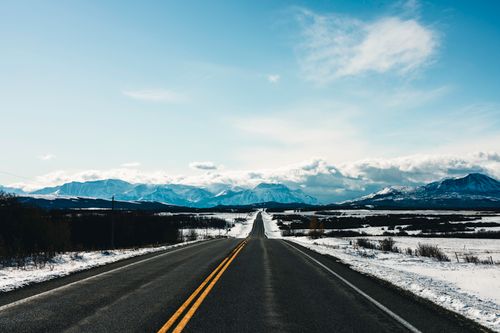 Free Explore the breathtaking winter landscape with open roads leading to majestic mountains in Waterton Park, Canada. Stock Photo