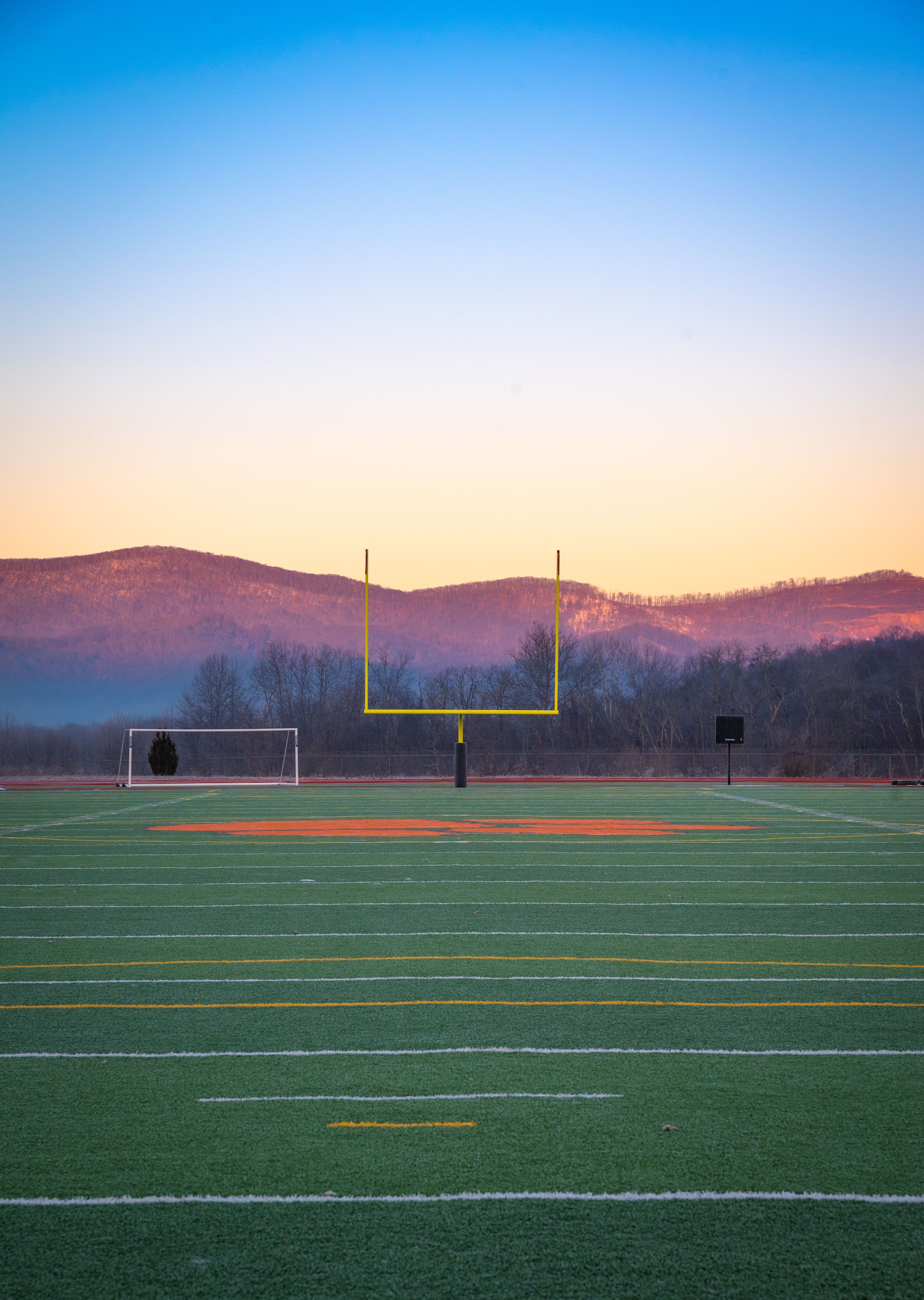 Representative licensed photograph of an American football goalpost at sunset; not June Jones, Hawaii's team or a memorial