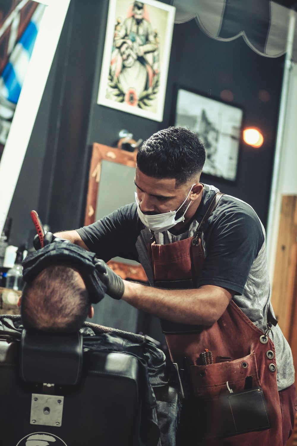 Barber washing a client's hair and face