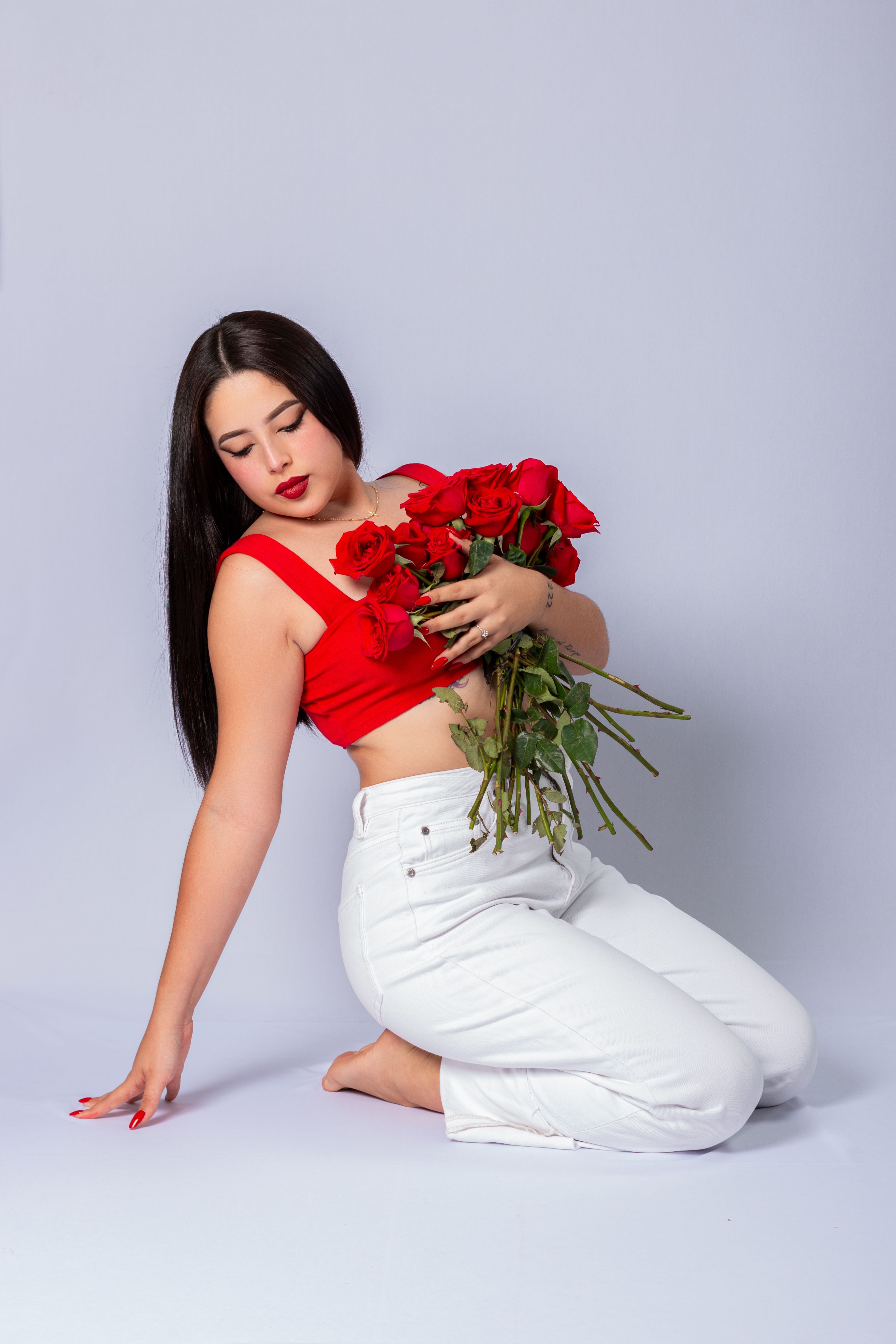 Brunette Woman Holding Bouquet of Red Roses · Free Stock Photo