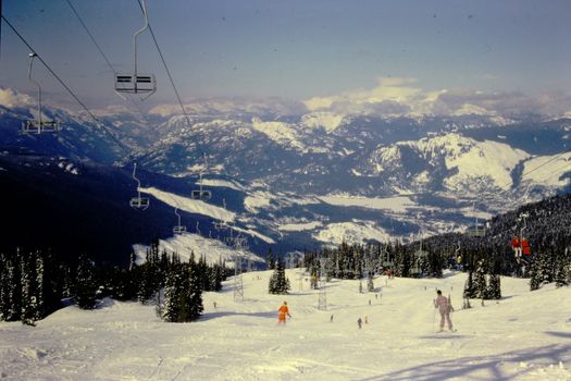 Experience the thrill of skiing on snowy mountains with stunning views and ski lifts.