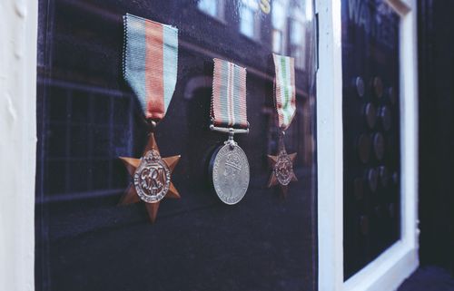 Free Close-up of historical medals displayed in a glass cabinet. Perfect for history and military themes. Stock Photo