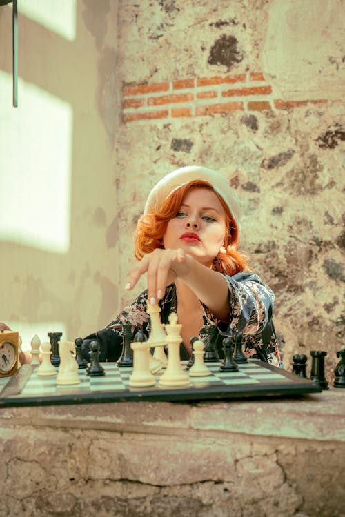 A woman playing chess with a man