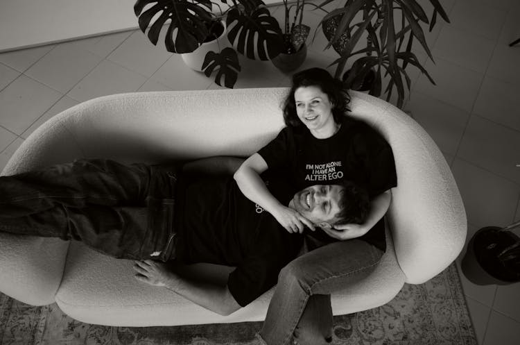 Smiling Couple On Couch In Black And White