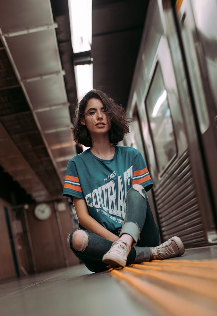 Woman Sitting On Subway Station