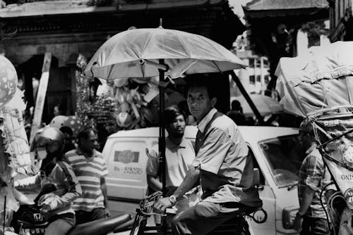 Grayscale Photography Of Man Riding A Bicycle