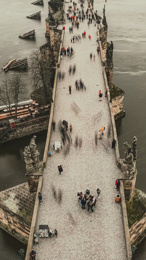 People walking on a bridge over water