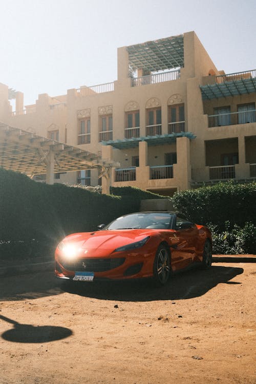 A red sports car parked in front of a building
