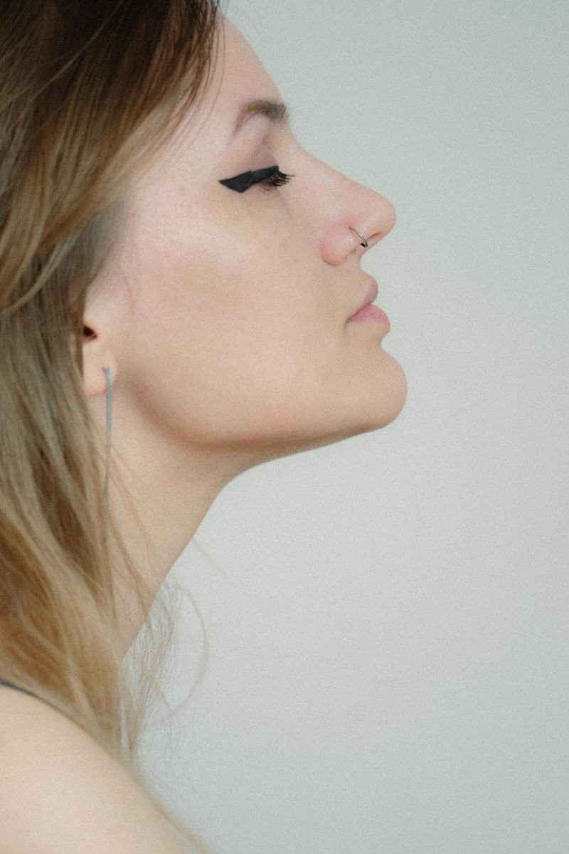 Profile portrait against a pale wall — Diana on Pexels