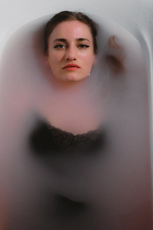 A woman in a bathtub with fog