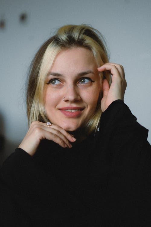 A woman with blonde hair posing for a portrait