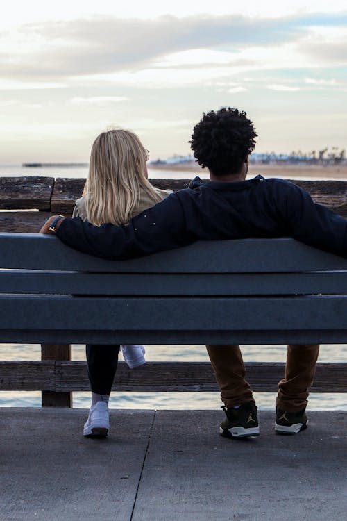 Back View of a Couple Sitting on a Bench 