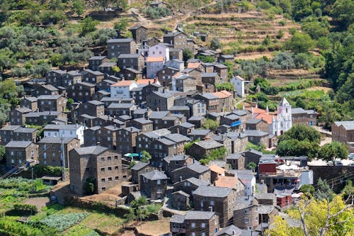 A village on a hillside with a view of the mountains