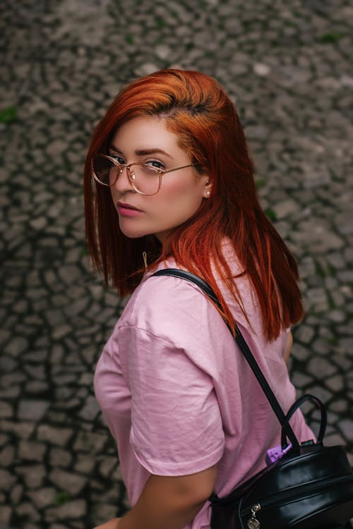 Free Woman Wearing Pink Shirt Carrying Black Backpack Stock Photo