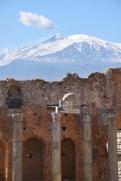 Ruins of the Ancient Theater of Taormina and the Mount Etna Stratovolcano