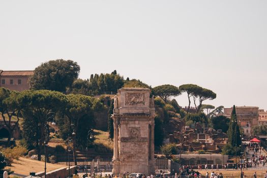Explore the iconic Arch of Constantine among the historic ruins of Rome, Italy under a clear sky.