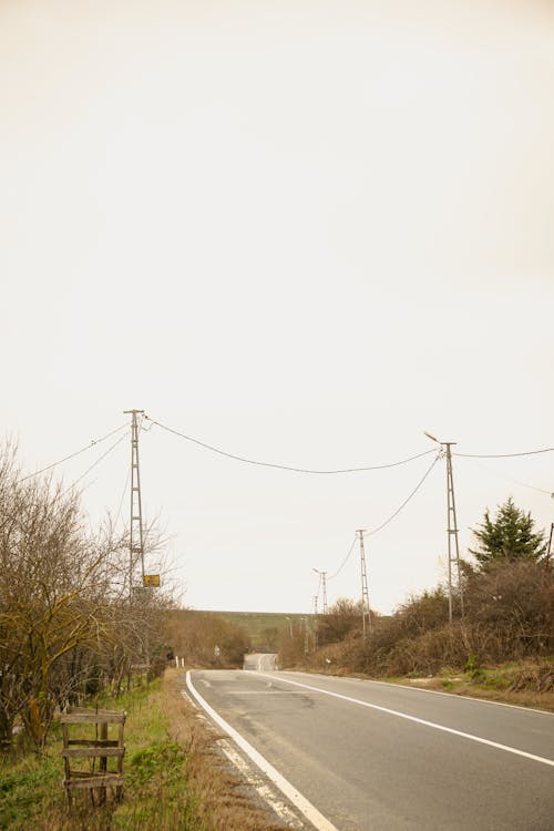 A road with a telephone pole and power lines