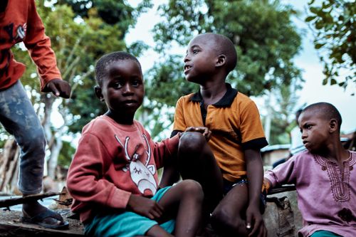 Free A group of African children playing outdoors, showcasing friendship and vibrant expressions. Stock Photo