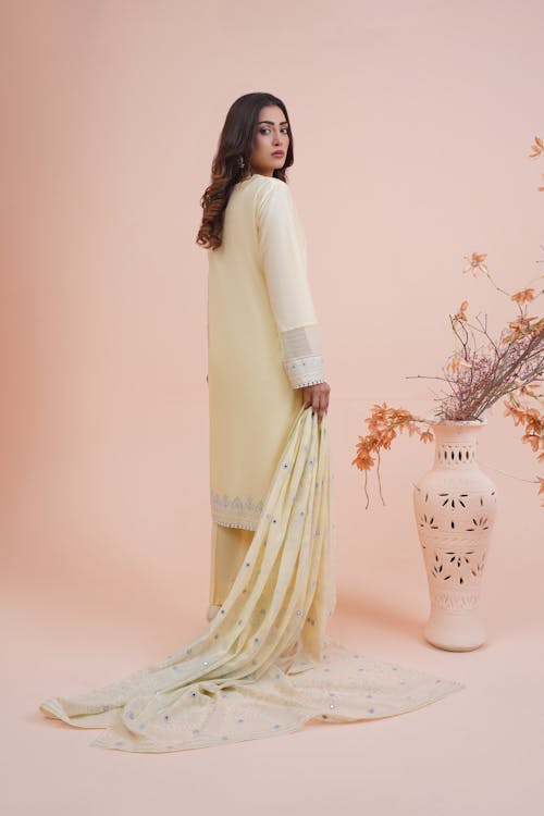 Woman Wearing Yellow Gown in a Studio 