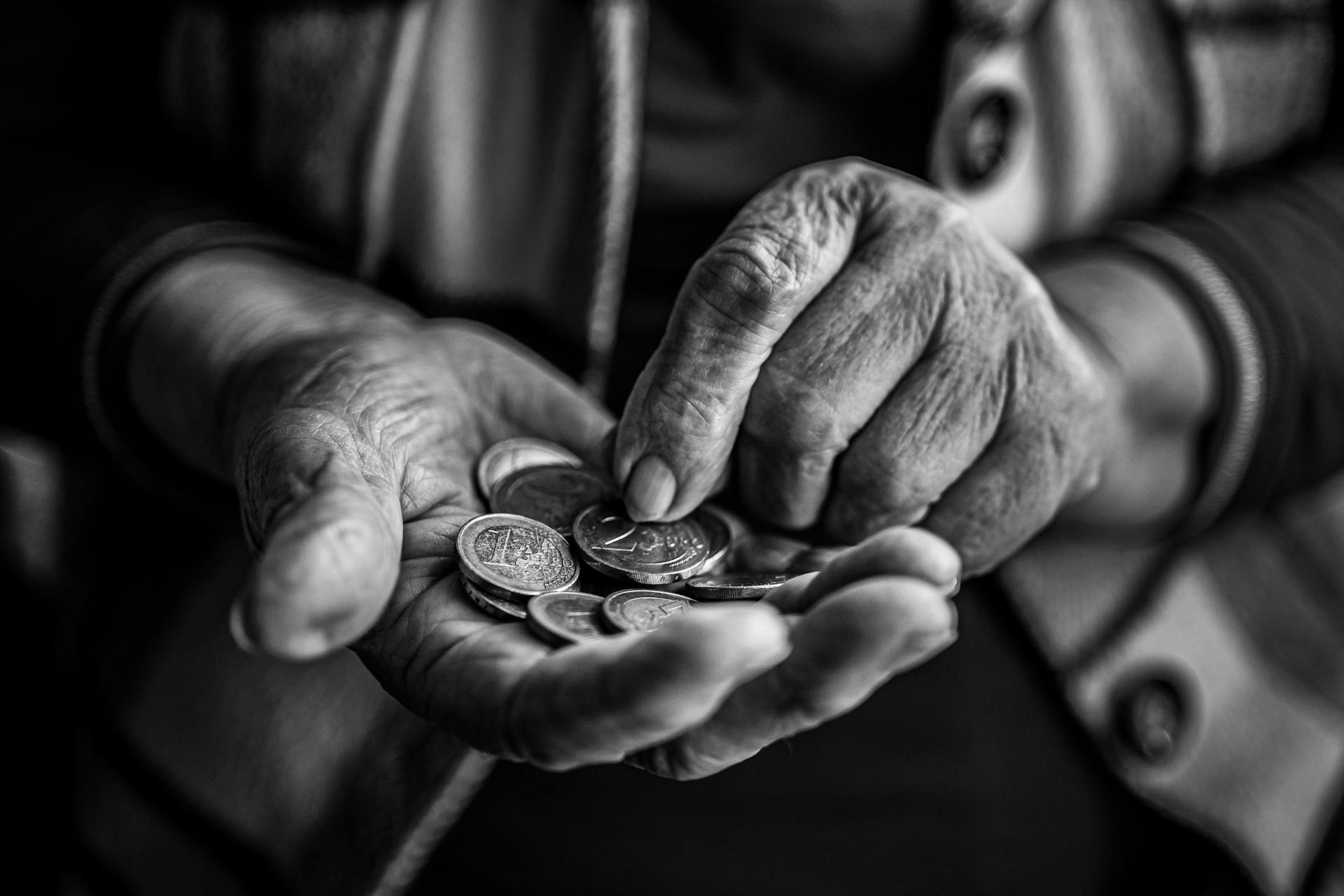 Elderly Person Hands Holding Coins