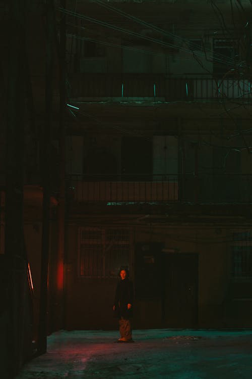 A person standing in the middle of an alley