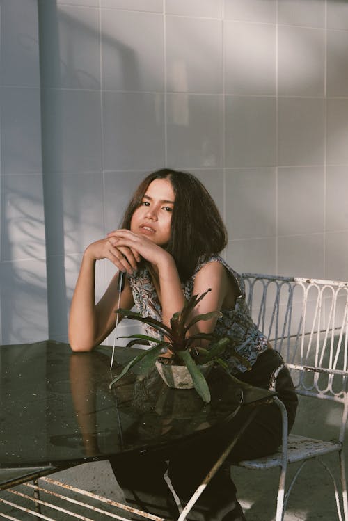 Woman Sitting On White Chair