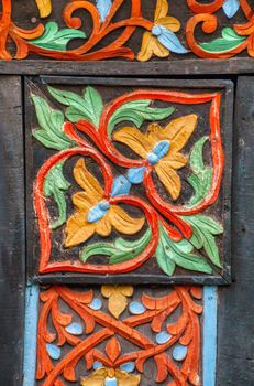 Detailed traditional wood carving with vibrant colors in Jakarta, Indonesia.