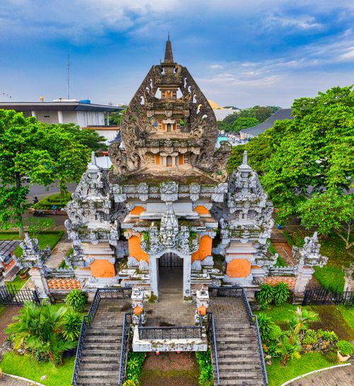 Free Captivating aerial shot of a traditional Balinese temple surrounded by lush greenery in Jakarta, Indonesia. Stock Photo