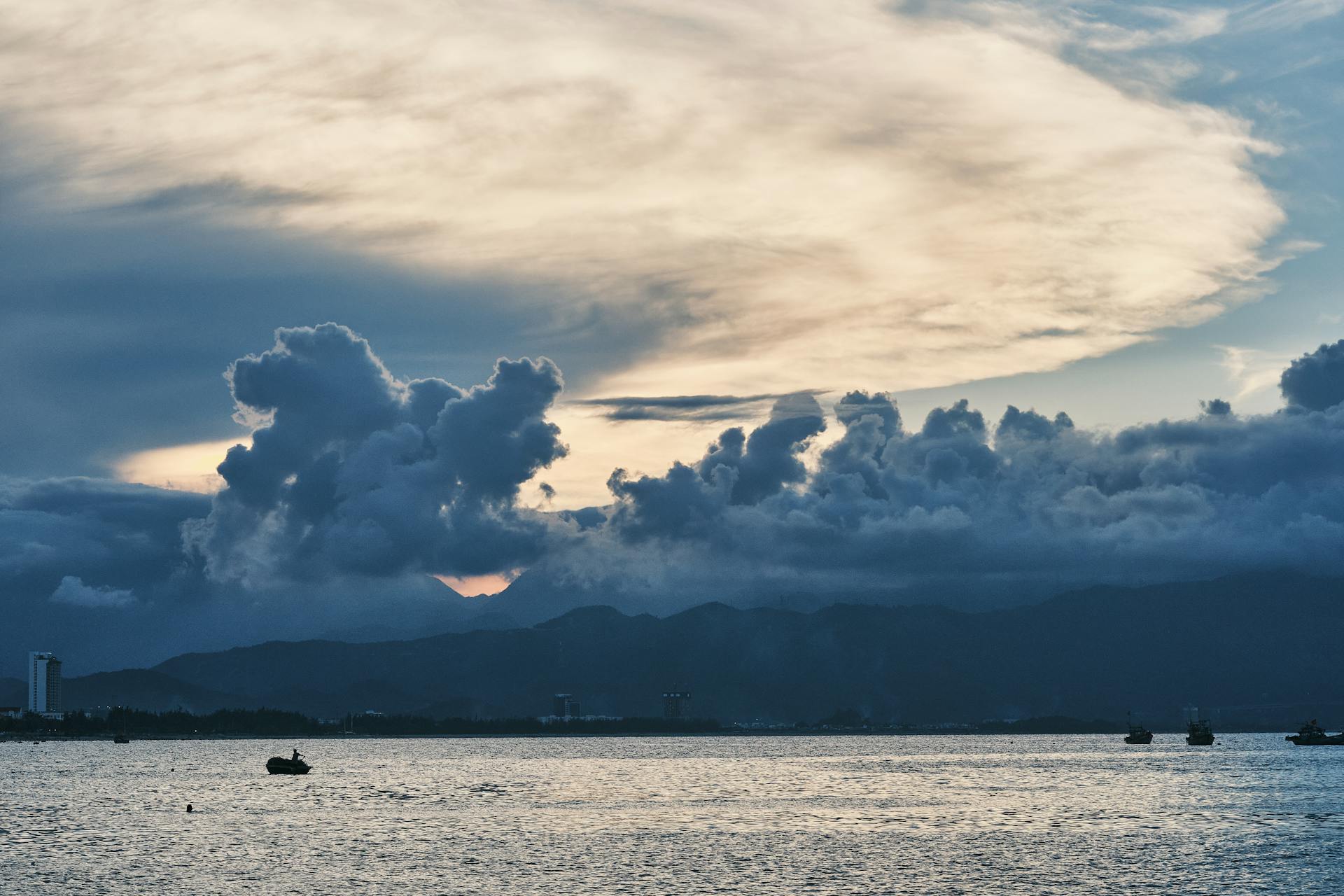 A striking sunset cloud formation above Da Nang Bay, capturing serene water and distant mountains.