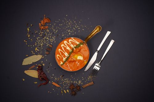 Free Top view of Indian curry with spices and cutlery on dark background. Perfect for food lovers. Stock Photo