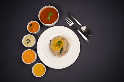 Indian Round Dish with Spices and Sauces on the Side