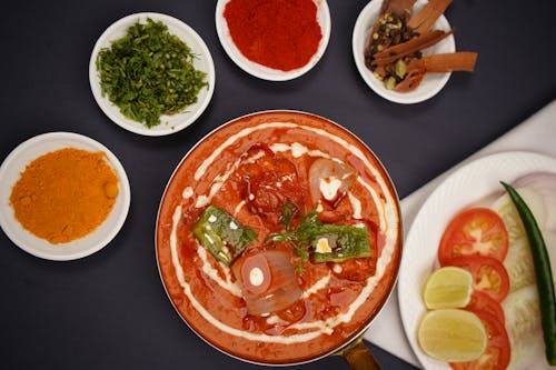 A plate of food with various spices and sauces