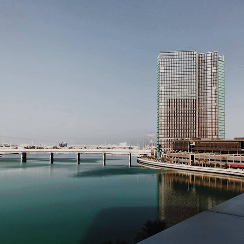 Gray Concrete Building Beside Water