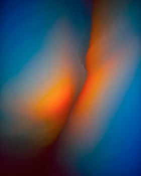 Abstract image with vibrant blue, yellow, and red gradients creating a dynamic background.