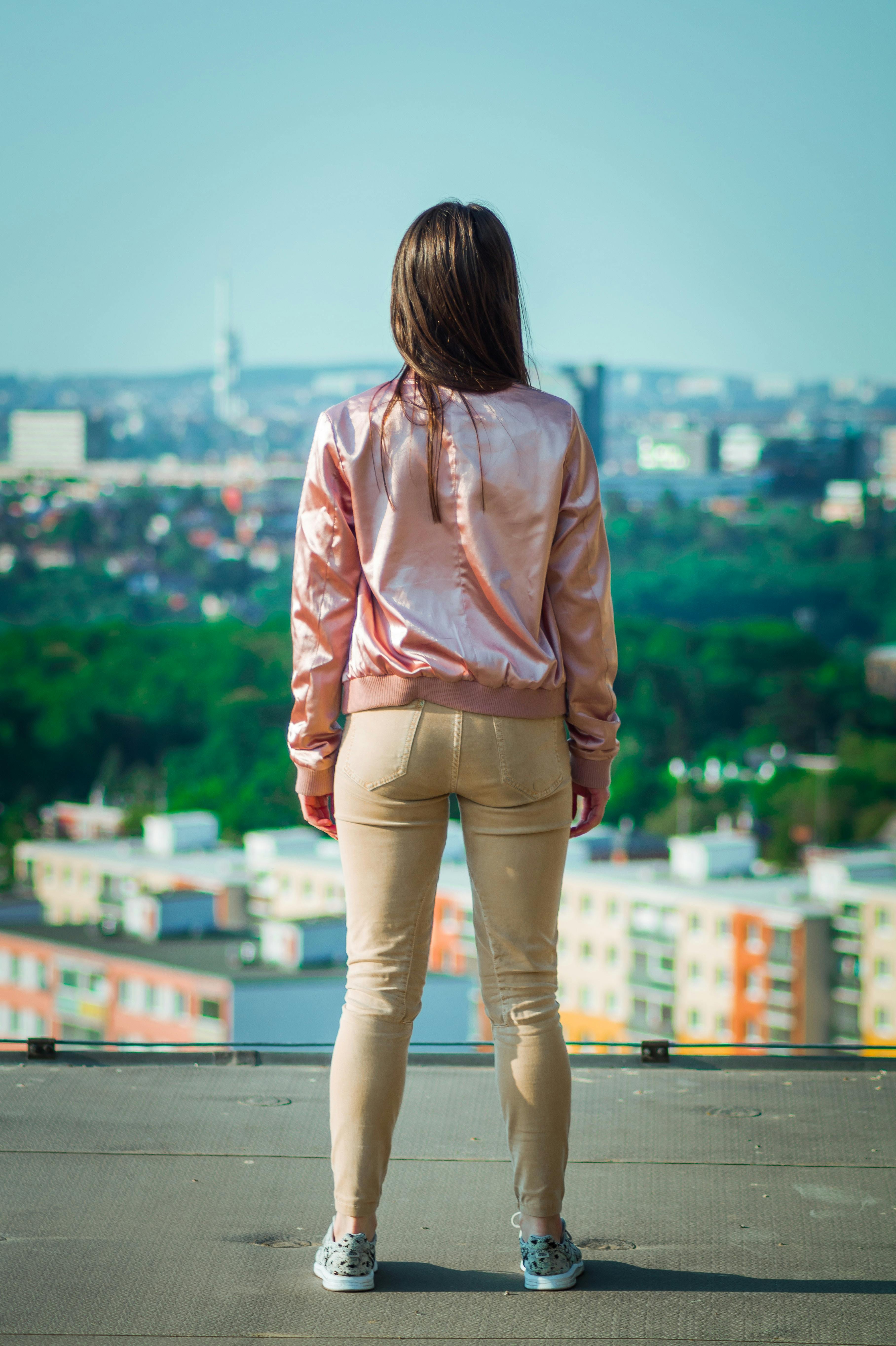 woman standing while wearing pink jacket