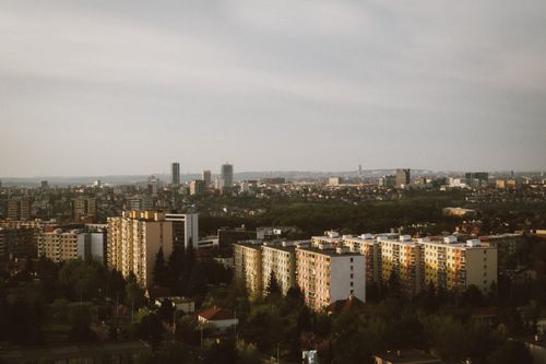 Free Expansive aerial view of a city's skyline with high-rise buildings and lush greenery. Stock Photo