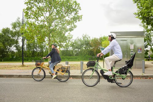 Free Woman and Man Riding Bicycles on Street Stock Photo