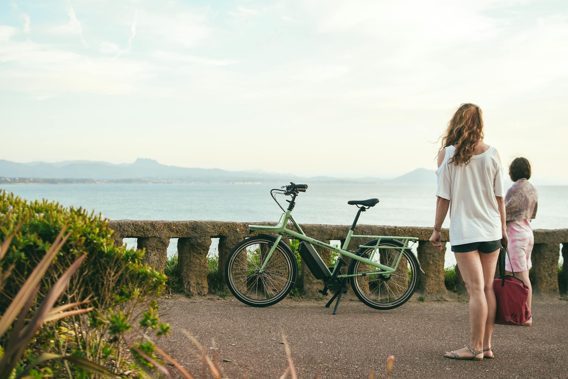 Women and Electric Cargo Bike on Promenade