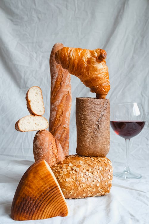 Free Cheese and Red Wine Glass by Display of Bread Stock Photo