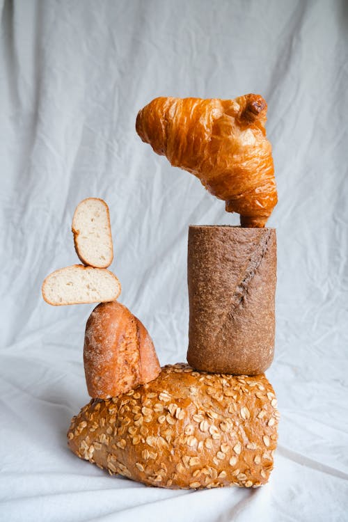 A sculpture of bread and croissants on top of a stack of bread