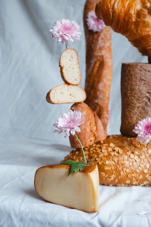 A bread and cheese display with flowers