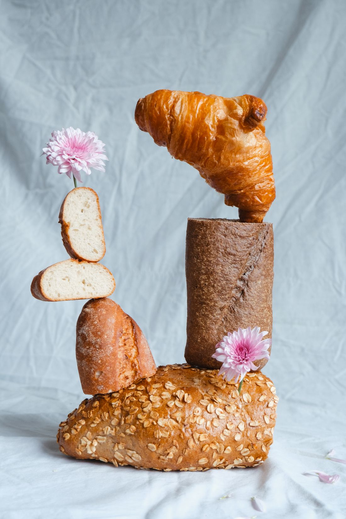 Fresh croissants and bread arranged with flowers