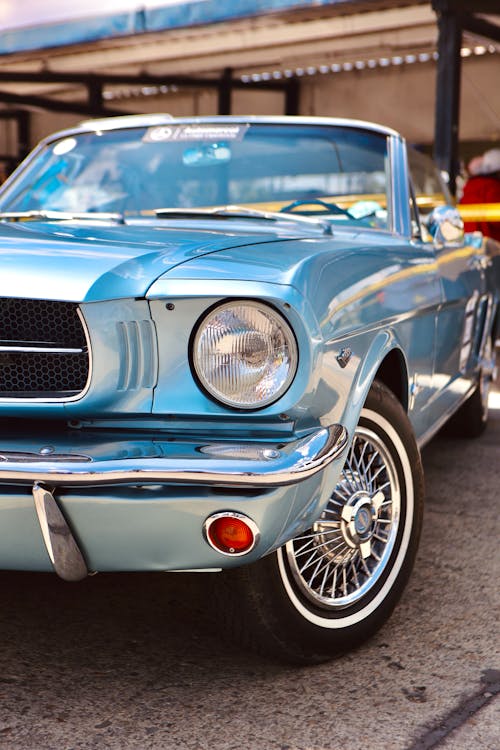 A blue ford mustang parked on the street