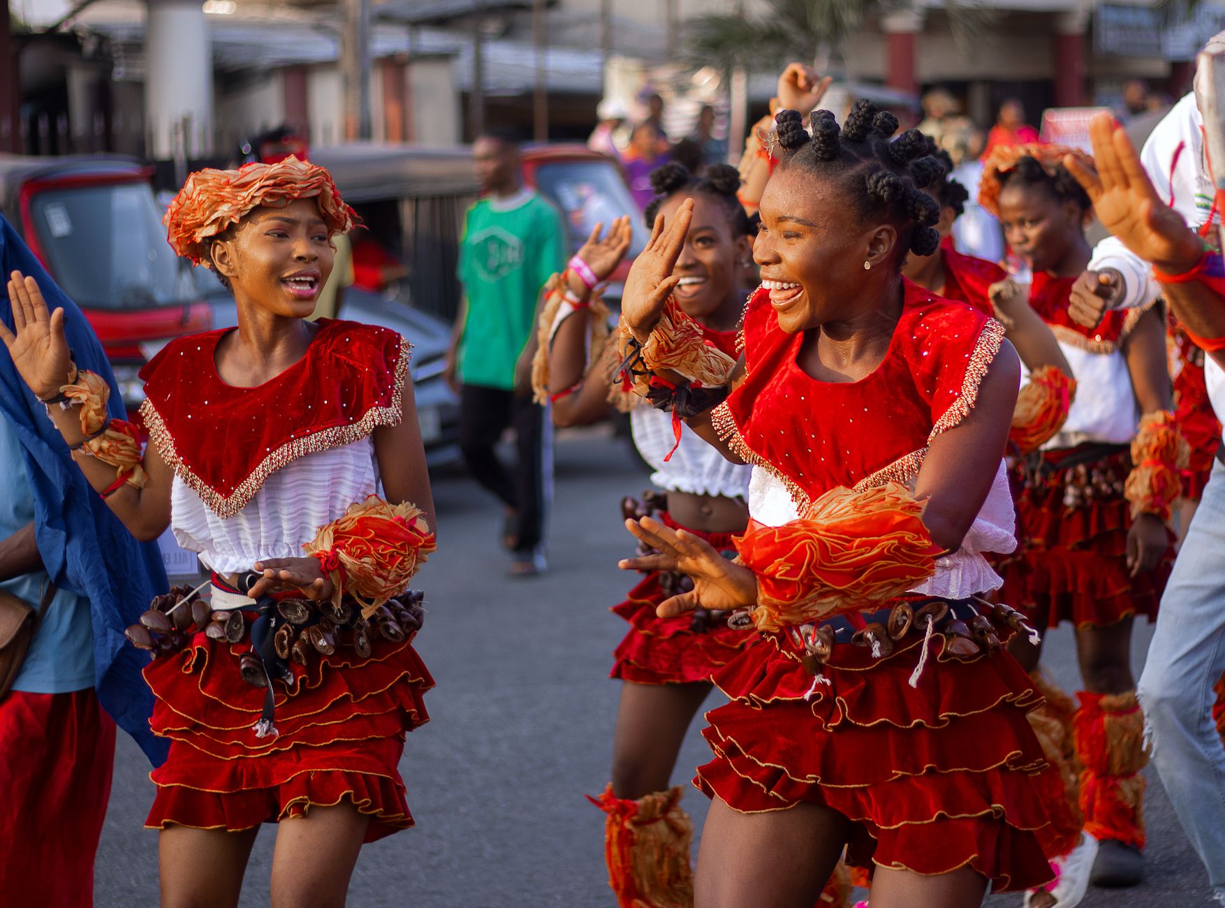 Vibrant street dancers in traditional attire at a lively festival in Uyo, Nigeria.