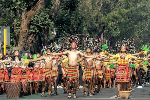 Women and Men Standing on Street in Festival