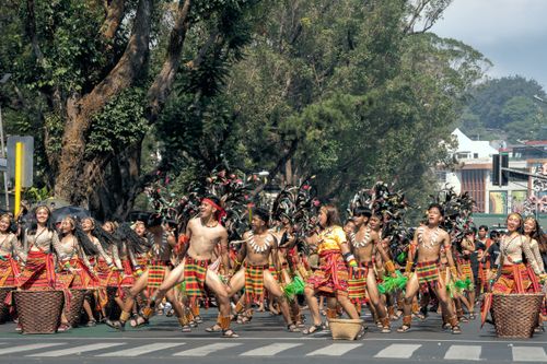 Free Colorful street parade with traditional attire during a festival in Baguio, Philippines. Stock Photo